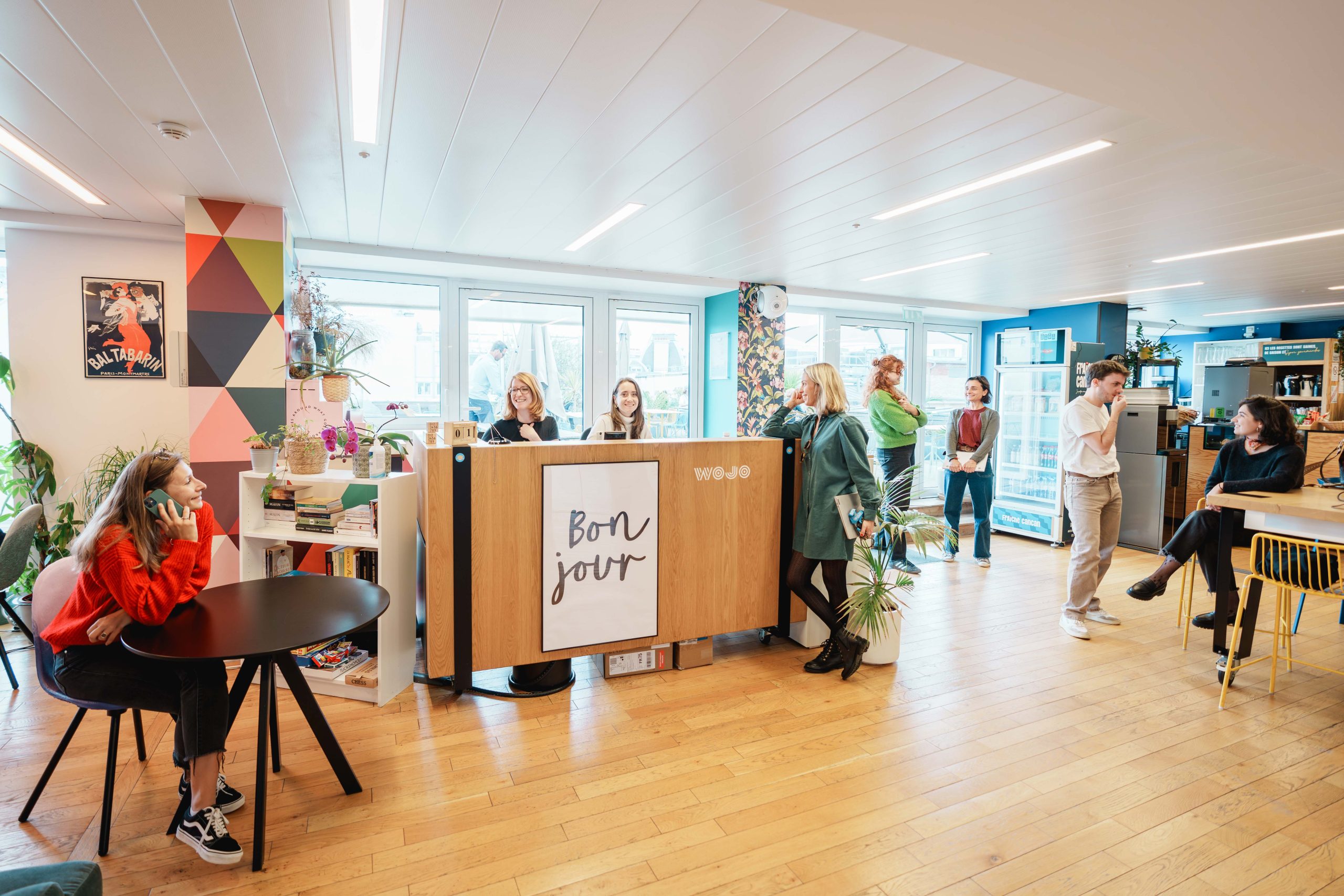 Des gens heureux au travail pour illustrer le baromètre Wojo sur le Retour au bureau